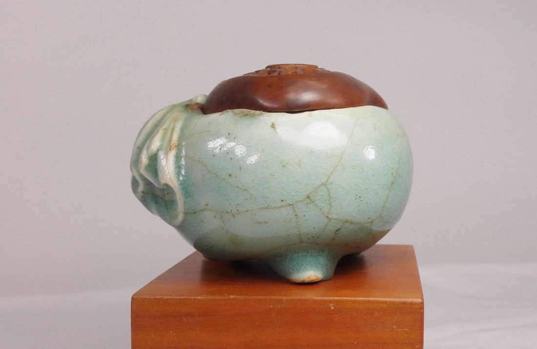 Chinese Celadon Green Glazed Incense Burner Censer Song: Unique Chinese celadon glazed censer in the shape of Budai's sack with intricate carved wooden lid, possibly Song dynasty. Height 3 Inches (7.6 cm) Width 4 1/4 Inches (10.7 cm) The censer has some o