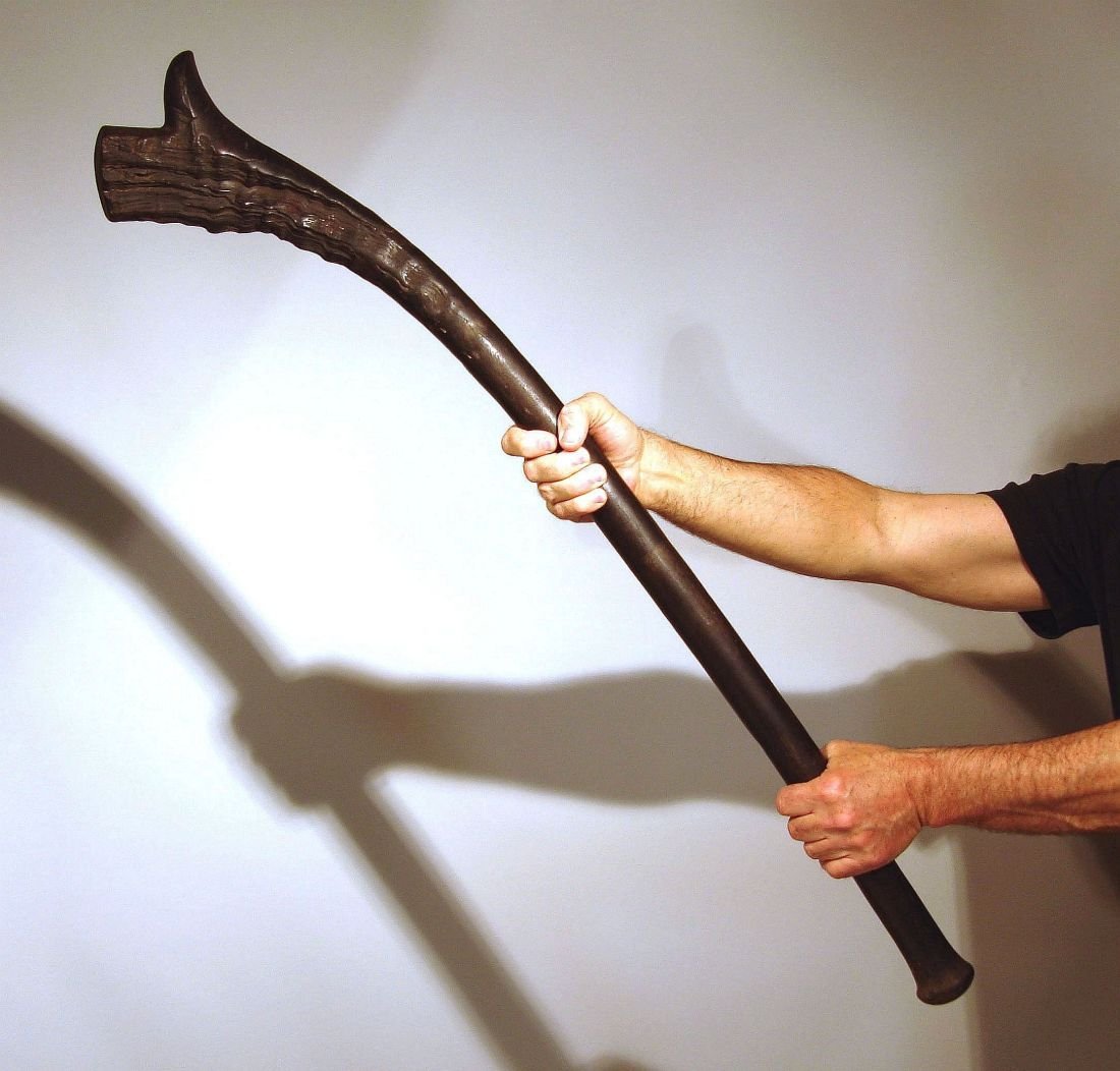 Antique Fiji Island Fighting Club: This beautiful Fiji club is carved from a dark, dense, very heavy wood; 19th century or earlier it has a dry slightly crusty surface, just as you would like to find it. The more polished areas of wear