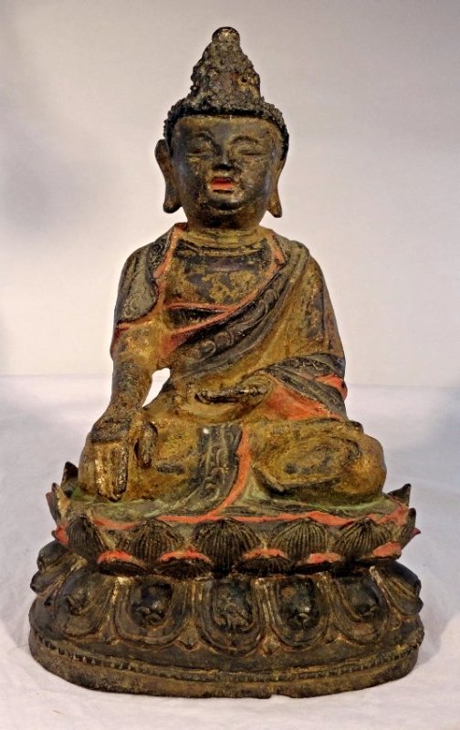 Early Chinese Ming Bronze Buddha Gilt Gold Lacquer: Early Chinese cast bronze Ming Buddha in a seated position atop a lotus flower. The Buddha was decorated at one point with gilding or gold lacquer and polychrome decoration. Much of the lacquer has wo