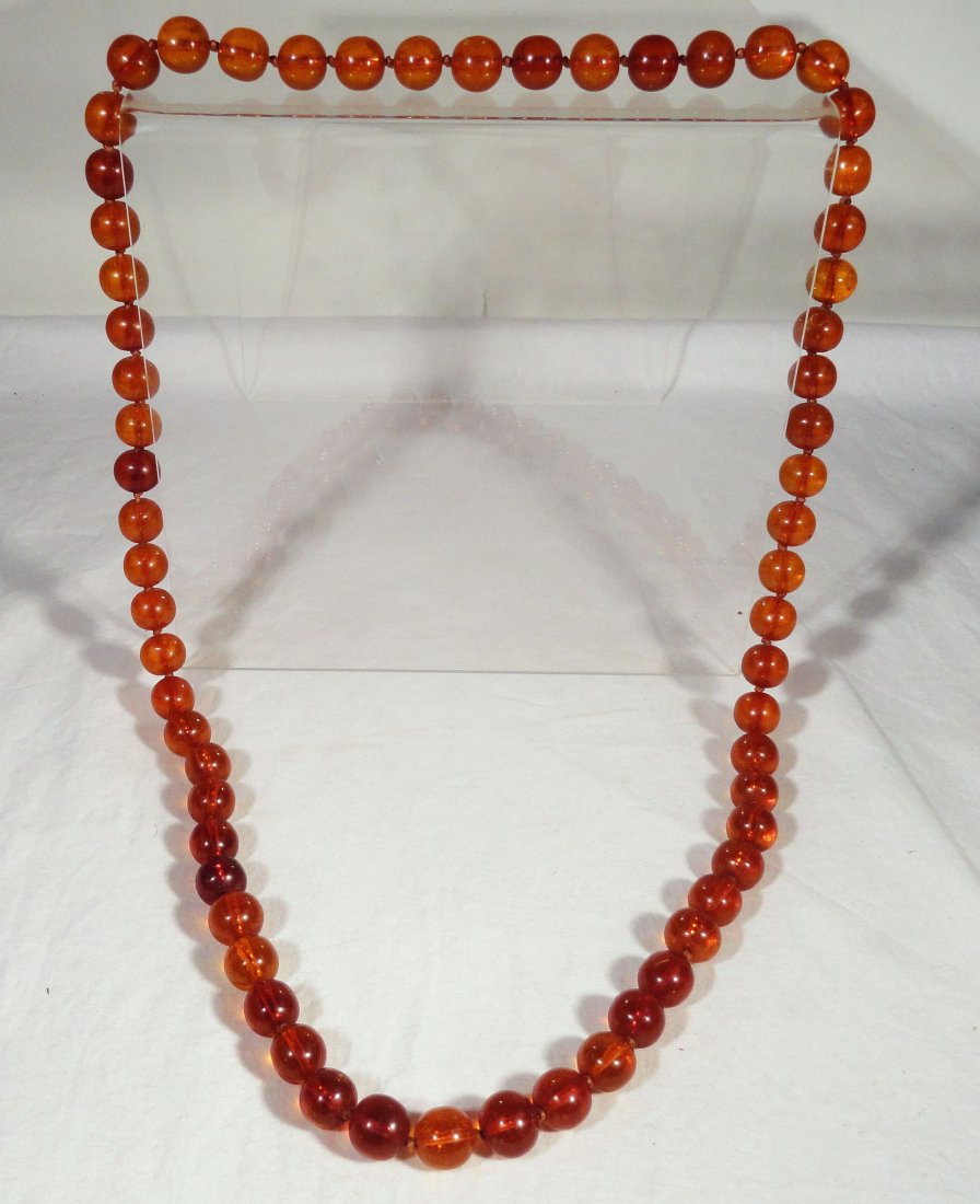 Honey Baltic Amber Bead Necklace Cognac Color 86g: Old strand of honey cognac colored Baltic amber. There are 62 beads in total, they are all translucent, they vary in color from light brown honey colored, to a medium brown cognac color with a few dar
