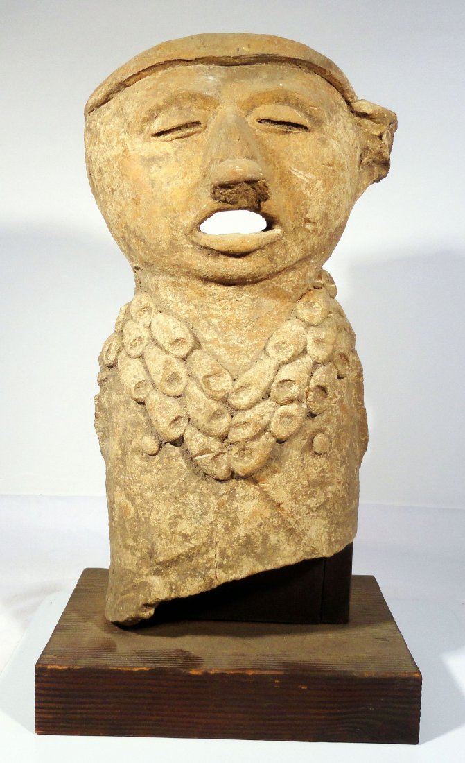 Vera Cruz Figure Pre-Columbian Terracotta Mexican: Late classic period central Vera Cruz pottery figure with a shell necklace, circa 600 - 900 A.D. The figure is missing its arms and lower torso and legs. The figure rests on a simple collector made wo
