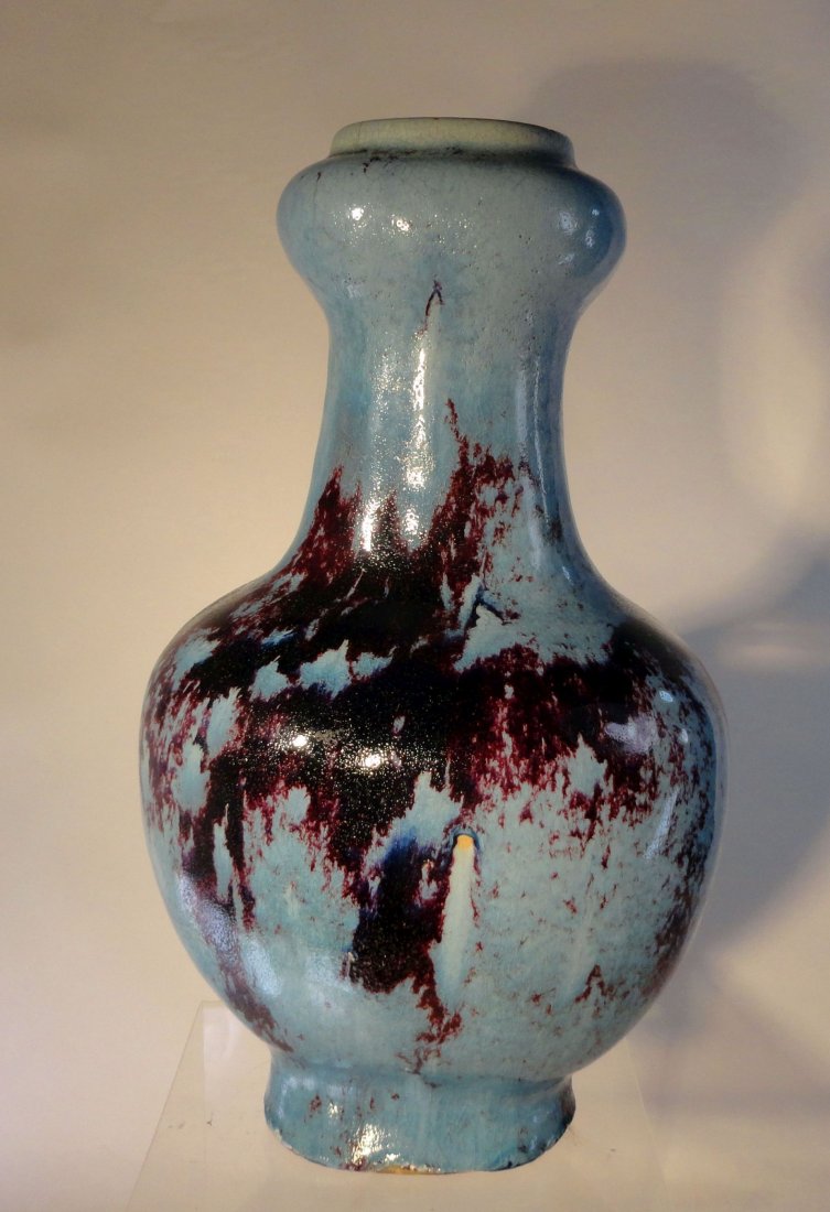 Large Chinese Style Jun Yao Flambe Vase Decorative: Unusual large vase, possibly Chinese, done in a Chinese style with blue Jun type vase with dark strawberry red/purple splashes around the body, possibly a failed flambe type glaze. We are unsure of th