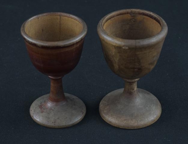 Wooden Egg Cups: Pair of PA turned wooden and decorated egg cups. Several cracks and decoration loss. Size: 3"H