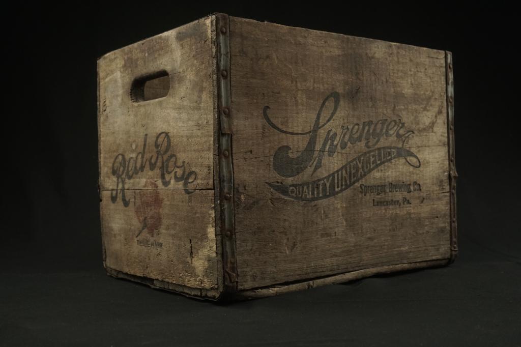 Vintage Lancaster Beer Crate Sprenger Brewery Comp.: Vintage Sprenger Brewery Comp. Lancaster, PA beer crate. Wood construction w/ metal bands. Very good w/ rust to metal bands. Size: 12" x 16 1/2" x 12"H