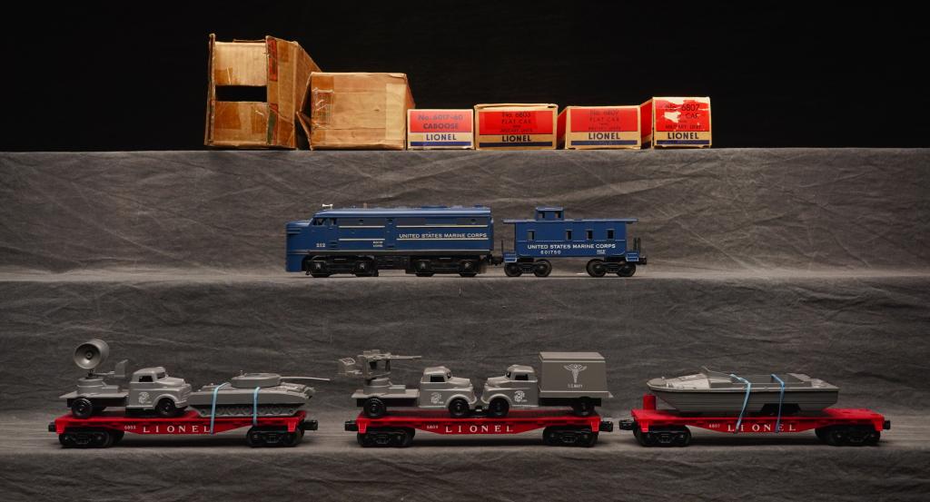 1958 Lionel Military USMC No.1591.: Set includes 212 diesel, 6803 flat military, 6807 flat military, 6809 flat military, 6017-50 caboose. Cars and engines in good original condition C-6. Box is in good condition with some flap loss. P