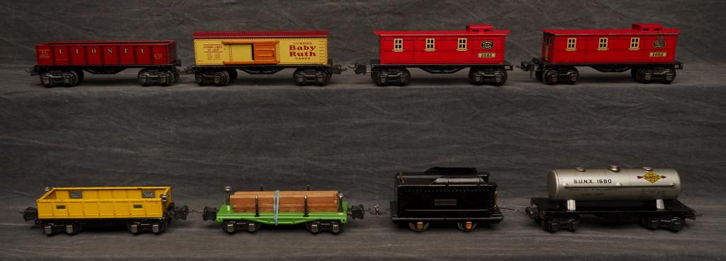 Miscellaneous Lionel Freight Cars.: To include 259 tender, 1679 Baby Ruth, 1680 oil car, 2651 lumber, 2652 gondola, 2677 gondola, two 2686 cabooses. Light wear to all cars. C-5