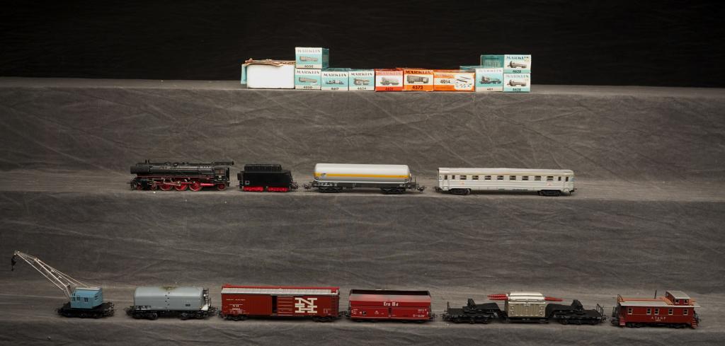 Group of Marklin Train Cars & Engine.: Group of Marklin train cars and engine. Marklin loco, mit transformator, crane, passenger car, plus others. Most appear to be in above grade condition all with original boxes. Engine box with tape and