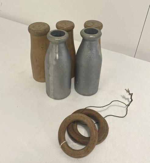 Milk bottle carnival game with wooden rings. (1 of 5)