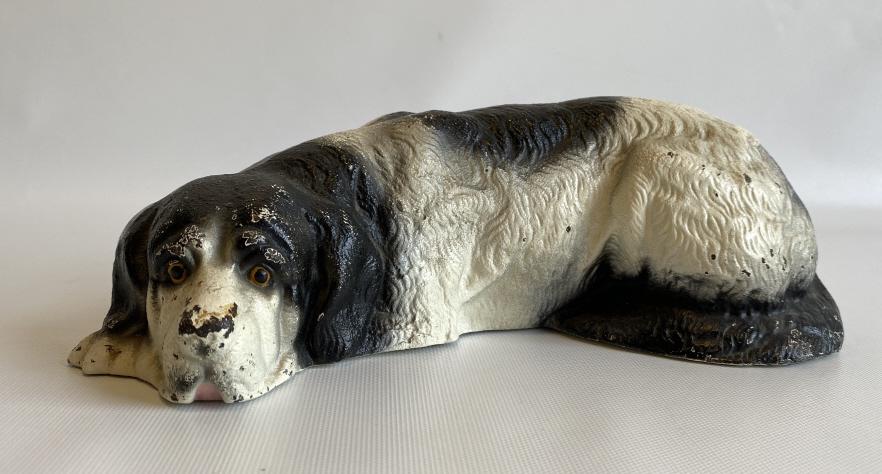 Early cast iron sleeping dog bank.: Measures 11" x 3.5". Great original paint surface.