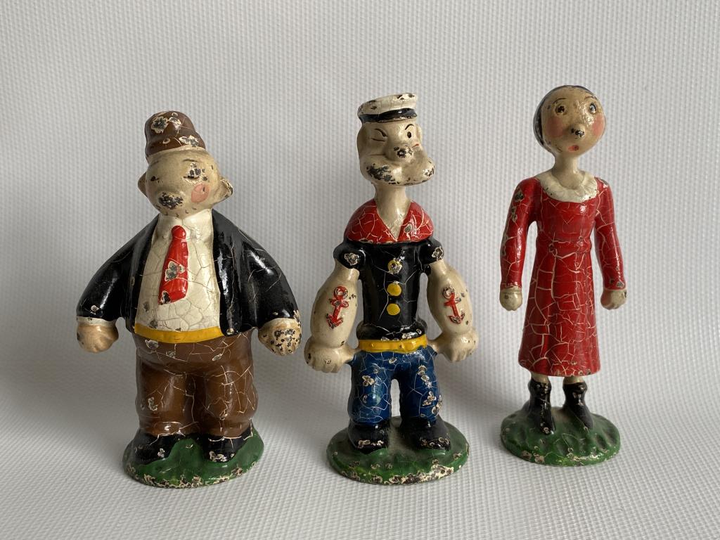 1920’s Hubley cast iron Popeye paperweights.: Crazing and some loss to the paint. Original surfaces. Figures measure approximately 3.25” high.