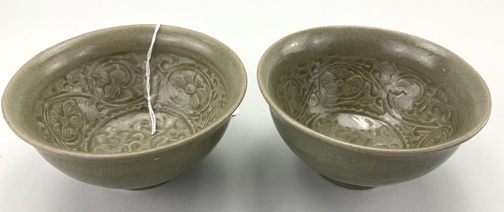 Pair of Antique Chinese Yaozhou Celadon Tea Bowls.: 2.5"Hx4.5"W. Carved with stylized peony flowers, foliate and scrolling vine motifs. Primarily produced in Northern China at the Chengguan kilns. Yaozhou ware is a type of stoneware, fired at high temp