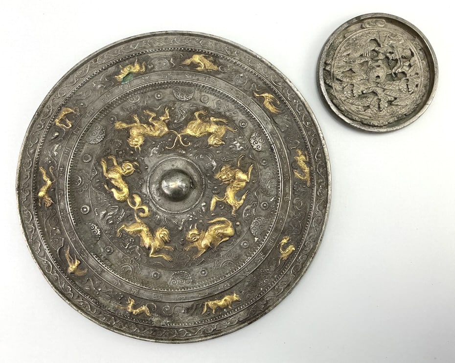 2 Antique Chinese Tang Style Bronze Mirrors.: Larger piece measures 12.5 inches in diameter. Larger mirror, Tang Dynasty style, cast with two registers, the outermost with the twelve animals of the zodiac, the second depicting six lions encirclin