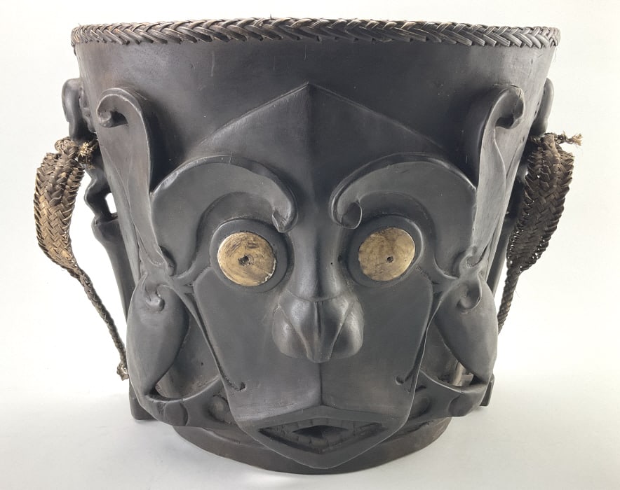 Dayak Tribal Carved Wood Udok Infant Carrier.: Measures 14 inches high by approximately 16 inches wide. Carved ironwood ‘Udok’ infant carrier, Dayak, Bahau, Borneo, late 19th/early 20th century. Carved mask back with bone inlaid eyes, 