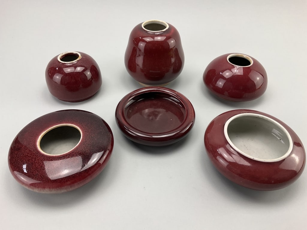 6 Various Chinese Oxblood Glaze Brush Washers.: Measure 1-4 inches high by approximately 3-5 inches wide. 6 various form antique/vintage Chinese porcelain oxblood glaze (langyao hong) calligraphy brush washers. One with an under-glaze spurious Chin