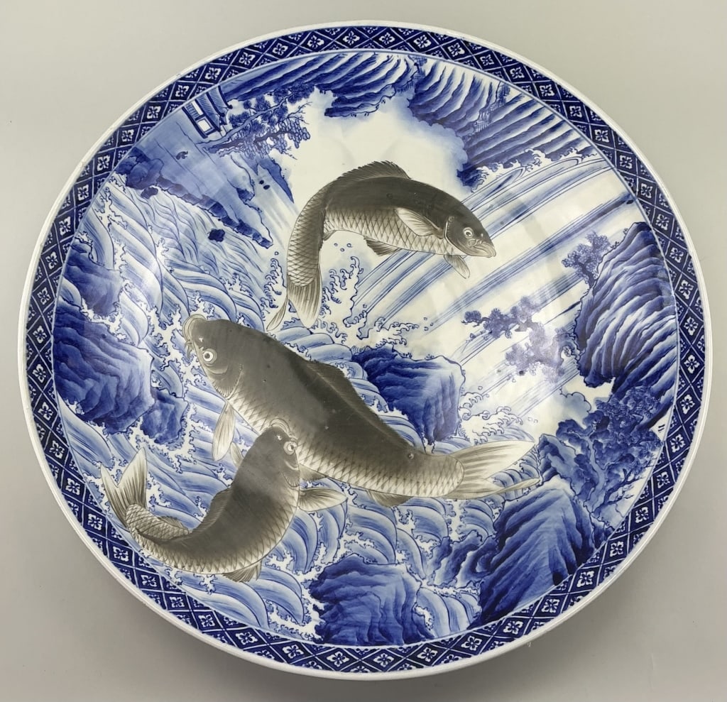 Oversized Japanese Blue & White Porcelain Charger.: Measures 24 inches in diameter. Unsigned, late Meiji period. Decorated with three koi fish painted en grisaille over waves and a landscape. Brocade pattern border. Condition: Very good with minor wear