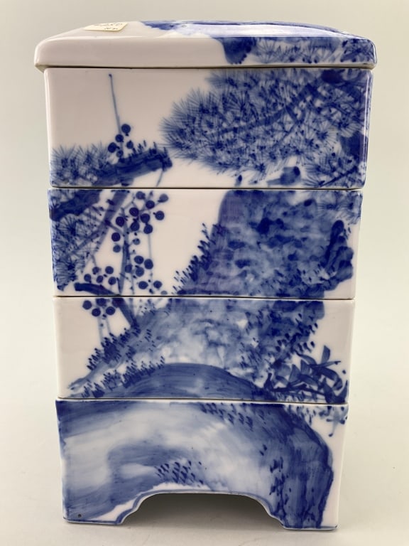Antique Japanese Porcelain Jubako Stacking Box.: Measures 11 inches high by 6 inches wide. Circa 1900, also known as a tiered bento box. Blue under-glaze (sometsuke) porcelain with pine tree plum blossoms and cranes, which are symbols of longevity. 