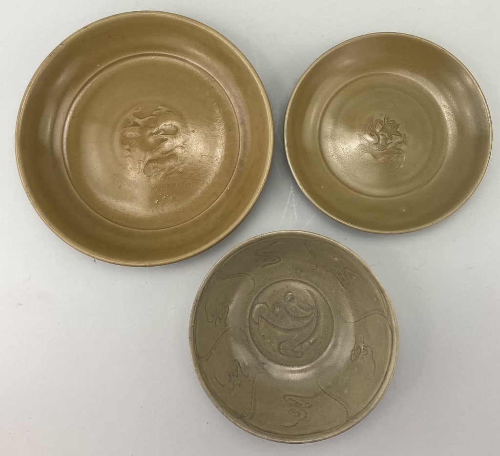 3 Chinese Longquan Style Celadon Bowls.: Largest bowl measures approximately 10 inches in diameter. Largest has carved dragon motif, other 2 have floral and foliate design. Distinctive green glaze, characteristic of celadon wares produced in