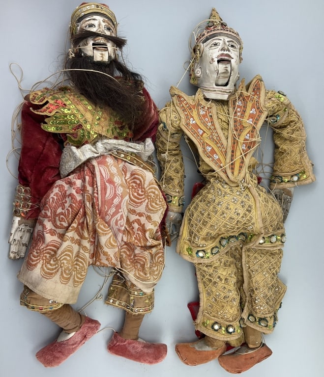 2 Burmese/Thai Marionette String Puppets.: Measure approximately 24 inches long. Two vintage folk art puppets with carved and painted heads, hands and feet, dressed in intricate colorful traditional clothing. Condition: Good with wear.**LOCAL 