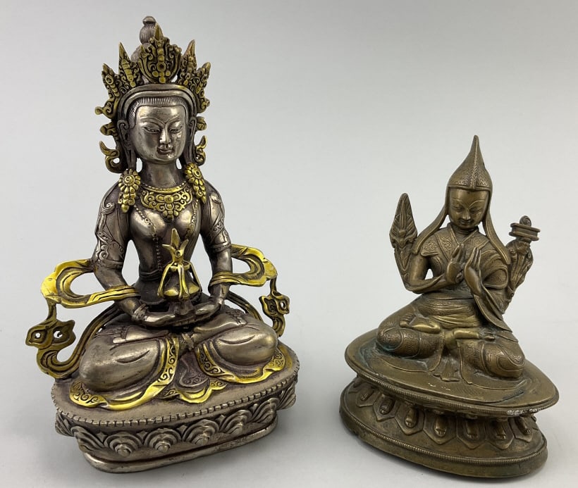 2 Bronze/Copper Tibetan Buddha Figures.: Larger figure measures 8 inches high. 1st: White copper Tara Goddess Dolma Bodhisattva statue with gilt highlights. 2nd: Bronze figure of the Tibetan Buddhist Master Je Tsongkhapa, founder of the Gelu