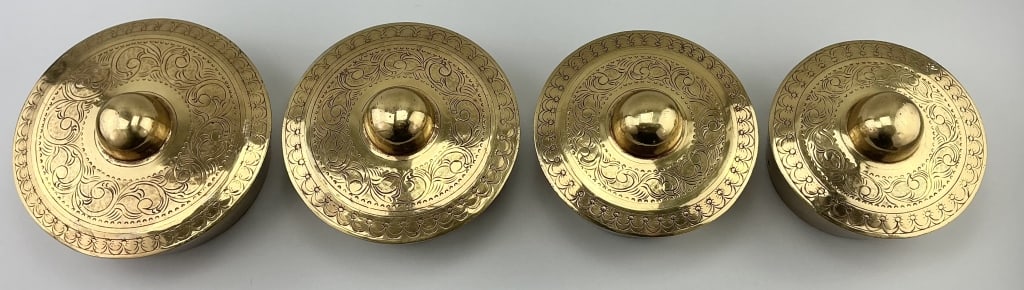 4 Antique Asian Etched Brass Kulintang Gongs.: Largest piece measures 9 inches in diameter. 19th century Southeast Asian; each top is engraved with scrolling foliate and drape motif. This traditional musical instrument has a unique construction. T