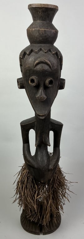 Antique African Chokwe Tribal Art Queen Figure.: Measures 34 inches high. Early 20th century, Angola, The Democratic Republic of Congo carved wood female figure with vessel on her head and wearing a raffia skirt. Condition: Good with minor wear.**LO