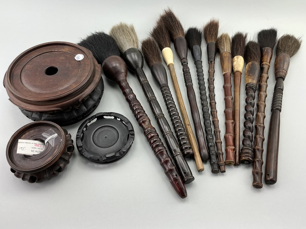 Chinese Calligraphy Brushes, Rosewood Stands.: Longest brush measures 18 inches long. 12 various antique/vintage wood and bamboo handle calligraphy brushes and 4 various rosewood vase pedestals. Condition: Good with use wear.**LOCAL PICKUP MUST BE