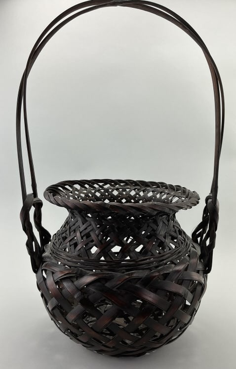 Japanese Takekago Bamboo Ikebana Basket.: Measures 20 inches high. These baskets are traditionally used for the Japanese art of flower arrangement. Features dark stained patina and loosely woven bamboo construction. Condition: Good, no loss o