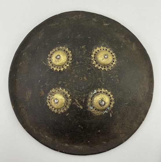 Antique Indo-Persian Leather Warrior Dhal Shield.: Measures 13 inches in diameter. Mid 19th century Persian or Maratha warrior shield. Circular form with four gold colored metal gear-like bosses. Condition: Good with wear and minor edge cracks.**LOCAL