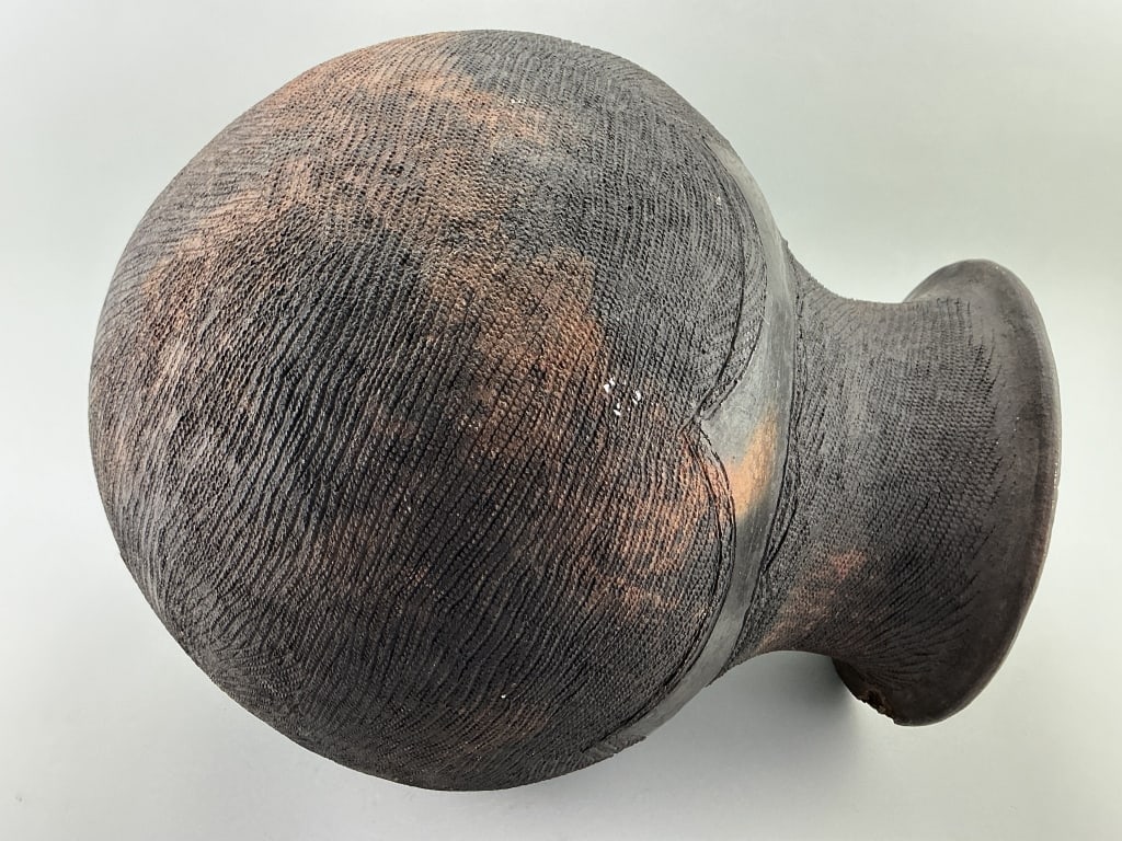 African Nupe Hand-Coiled Pottery Water Vessel.: Measures 19 inches high. Incised horizontal track wheel decoration with chevron shoulder. Condition: Good with a rim chip. **LOCAL PICKUP MUST BE BY APPT ONLY POST AUCTION ONLY ON SPECIFIC DATES:CALL 