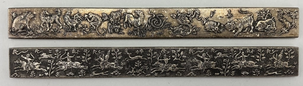Two Chinese Tibetan Silver Scroll Weights.: Measure 9.25 inches long. Two various relief carved weight bars with zu yin (pure silver) touch marks on verso. 1st: Depicting the 12 animals of the Chinese zodiac. 2nd: Depicting hunters on horseback