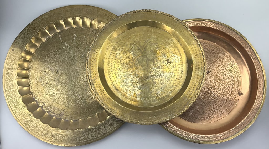 3 Indian/Moroccan Brass & Copper Trays.: Largest piece measures 22 inches in diameter. Hand-hammered and elaborately engraved decoration. Condition: Good with minor wear. **LOCAL PICKUP MUST BE BY APPT ONLY POST AUCTION ONLY ON SPECIFIC DATE