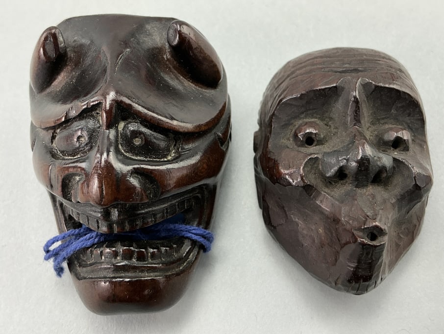 2 Antique/Vintage Japanese Carved Wood Netsuke.: Largest measures 2 inches. 1st: Shikami carved fierce demon-face. 2nd: Netsuke carved as a theatrical mask of Usofuki with its characteristic whistling lips and ridiculous expression. Condition: Good,
