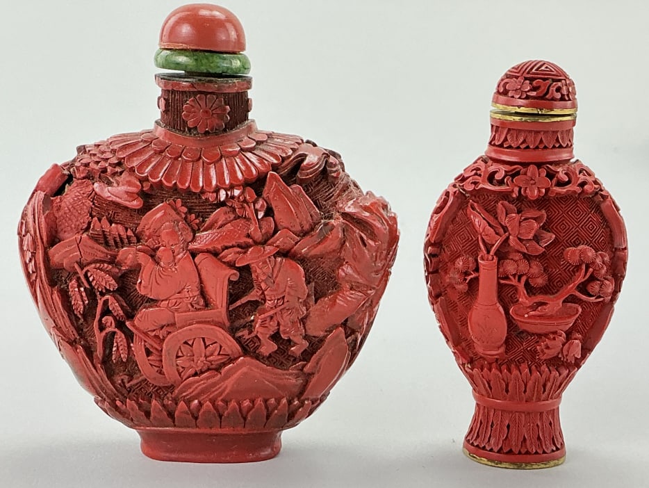 2 Antique Chinese Carved Cinnabar Snuff Bottles.: Measure 3 and 3.5 inches high. One depicts figures and horses, other depicts bonsai tree and lotus flowers in vase. Condition: Very good. **LOCAL PICKUP MUST BE BY APPT ONLY POSTAUCTION ONLY ON SPECIF