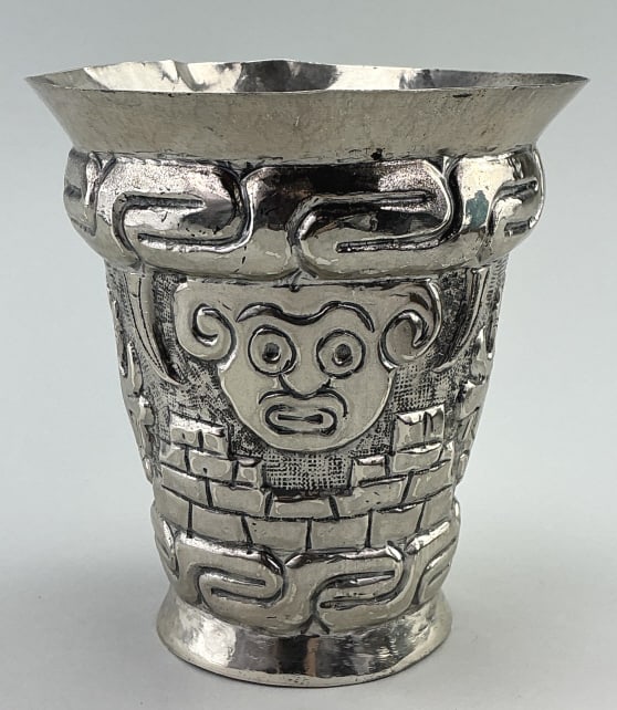 Peruvian .900 Silver Inca Aztec Tumbler.: Measures 5.25 inches high. Hand chased Inca or Chimu style depicting deity Viracocha. Used as ceremonial drinking vessels and presentation gifts. Condition: Good with light wear. Weighs 630.5g.**LOCAL