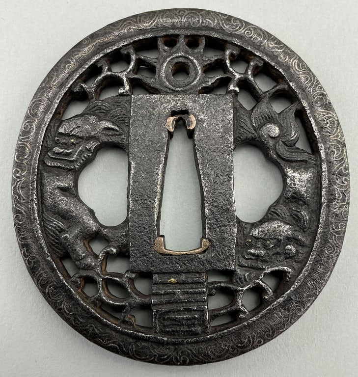 Japanese 19th Century Silver Inlaid Iron Tsuba.: Measures 3 inches in diameter. Antique iron Samurai sword (katana) guard with foo dog motif and scrolling silver inlays on edge. Condition: Good with wear and pitting. **LOCAL PICKUP MUST BE BY APPT O