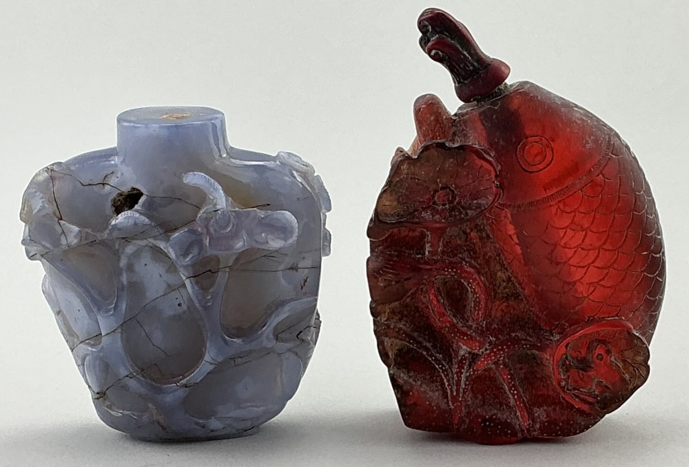 Two Antique Chinese Carved Snuff Bottles.: Measure 2.5 and 3 inches high. Cameo floral and foliate carved blue agate bottle and natural red amber carved koi fish and lotus flower bottle. Condition: Good with natural striations and inclusions. 
