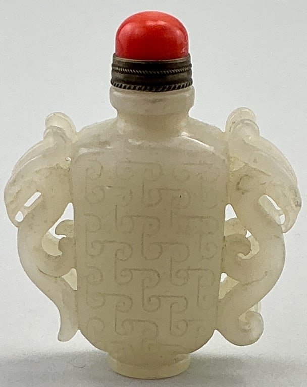 Antique Chinese Carved Nephrite Jade Snuff Bottle.: Measures 2.75 inches high. Likely Qing dynasty (1644–1912). Featuring double dragon handles, body carved with archaistic motifs and red aventurine cap. Condition: Good with natural striations an