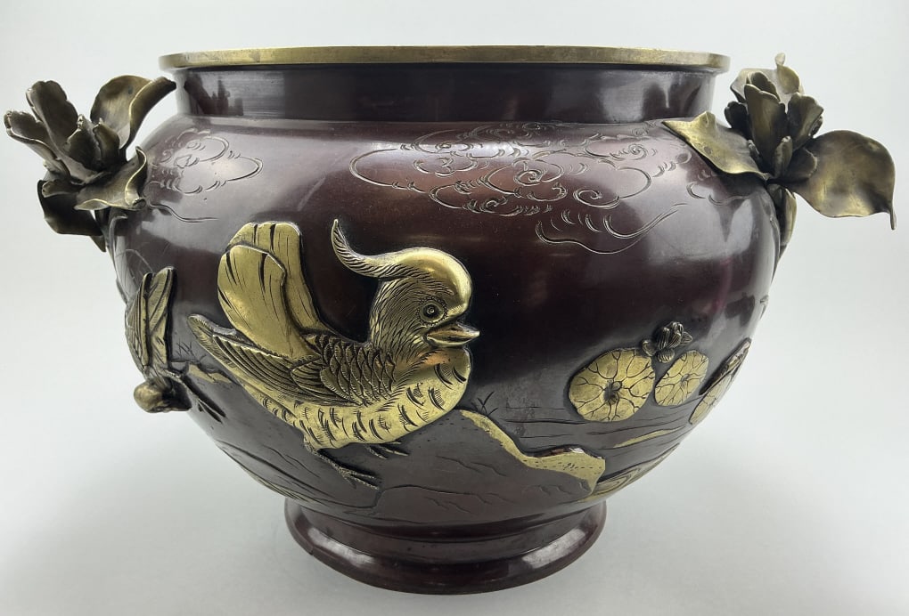 Antique Japanese 2-Tone Bronze Jardiniere.: Measures 15.5 inches wide. Meiji Period (1868-1912). Sculpted bird and floral motif on exterior, incised stork and landscape interior. Condition: Good with minor wear. **LOCAL PICKUP MUST BE BY APPT O