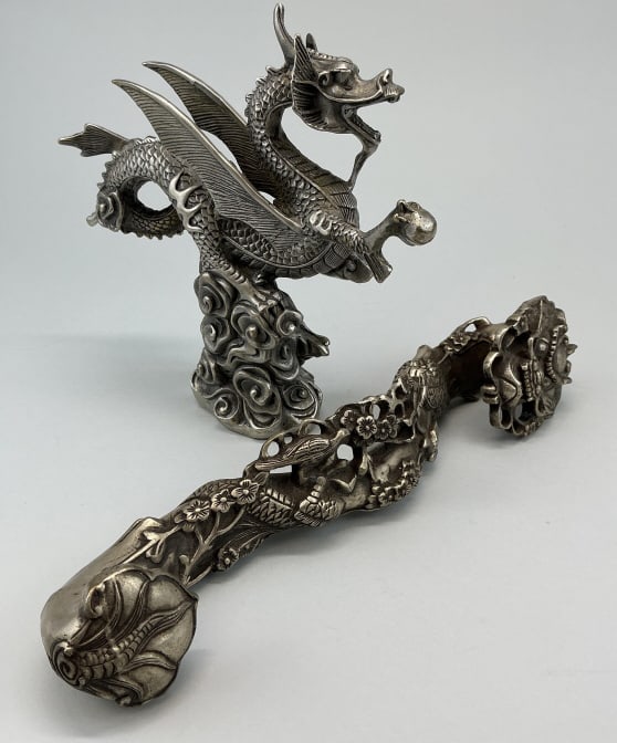 Chinese Bronze Ruyi Scepter & Dragon Okimono.: Measures 7.5 inches high. Pewter washed bronze okimono (sculpture) of a dragon clutching a pearl, mounted on a stylized cloud formation. Pewter washed bronze Ruyi with a Dragon, its face is the upper 