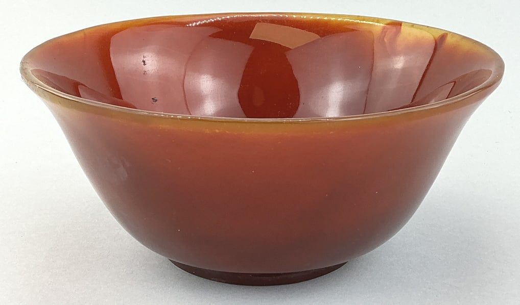 Chinese Carved & Polished Carnelian Agate Bowl.: Measures 6 inches in diameter. Likely late Qing period (1644-1911). Circular form with flared rim and ring-footed base. Translucent tones of yellow, orange and red. Condition: Very good with minor wea