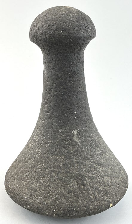 19th Century Tahitian Basalt Poi Pounder.: Measures 7.5 inches high. Fine example of carved volcanic stone with convex base, tapered shaft and knob handle finial. Used to mash cooked taro root into a paste known as poi. Condition: Very good.**