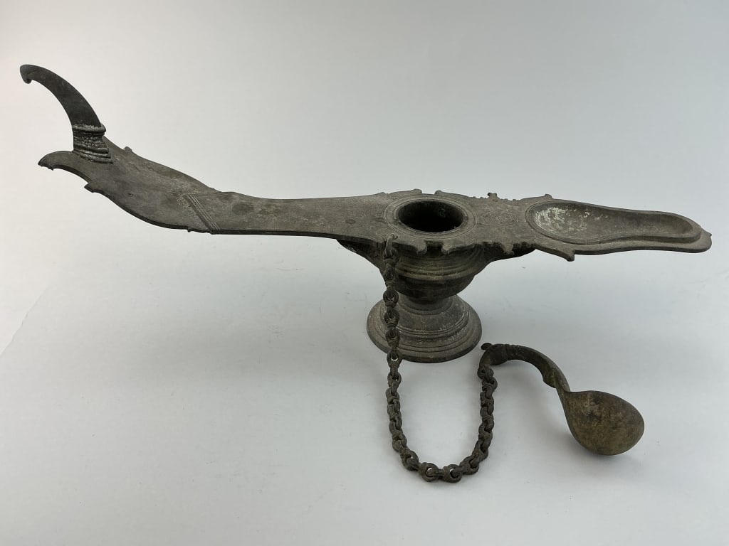 Antique Hindu Changalvetta Ritual Oil Lamp.: Measures 18 inches long. Indian 19th century with distinctive long handle and matching ladle attatched by a chain. Condition: Good with darkened patina. **LOCAL PICKUP MUST BE BY APPT ONLY POSTAUCTION