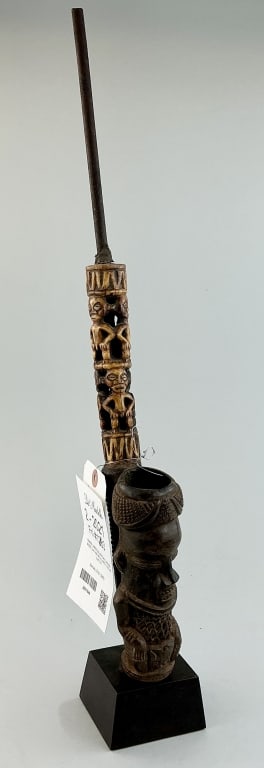 African Carved Wood, Clay & Metal Smoking Pipe.: Measures 22 inches high, including display. Early 20th century, Bamileke people, Cameroon pipe with carved effigies. Condition: Good with wear. **LOCAL PICKUP MUST BE BY APPT ONLY POSTAUCTION ONLY ON 