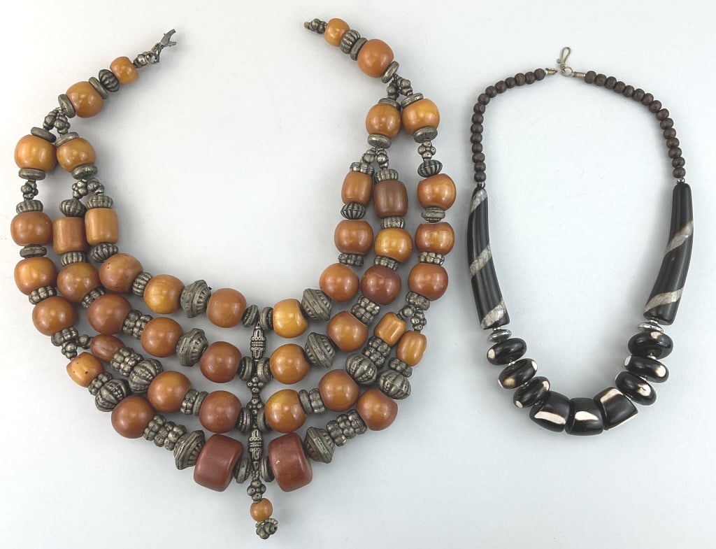 Vintage Faux Amber and Black Horn Necklaces.: Horn necklace measures 23.5 inches long. African 4-strand phenolic resin (amber imitators) trade bead and silver necklace. Vintage Black horn (water buffalo) beaded necklace. Condition: Very good.**LO