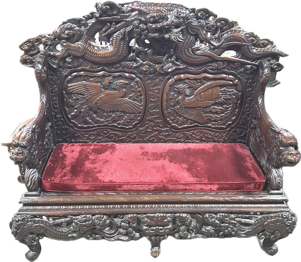 Vintage Chinese Carved Mahogany Dragon Settle.: 58 inches long x 23 inches wide x 50 inches tall. Profusely carved bench with elaborately carved dragon crest, arms and skirt, with bold double phoenix back panels. Condition: Very good.**LOCAL PICKUP