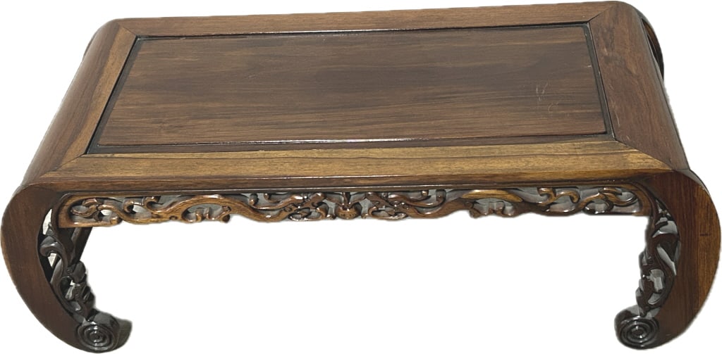 Chinese Carved Huanghuali Kang Table.: 37.5 inches long x 16.5 inches wide x 13 inches tall. Antique/vintage tea table featuring fruit and scroll carved apron and elephant trunk legs with rosette feet. Condition: Good with minor wear.**LOC