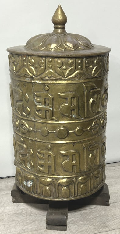 Antique Tibetan Buddhist Brass Prayer Wheel.: 17.5 inches diameter x 39 inches tall. Also known as a Mani wheel, often crafted in Nepal, embossed with the sacred mantra Om Mani Padme Hum. This mantra is deeply associated with Avalokiteshvara, the
