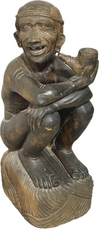 Vintage African Makonde Elder Ironwood Carving.: 33.5"Hx11"Wx16"D. Approximately 50 lbs. Likely Makonde carving from Tanzania, elder figure is in a squatting/seated position holding a pipe. Condition: Some splits in the wood. Head appears to have a