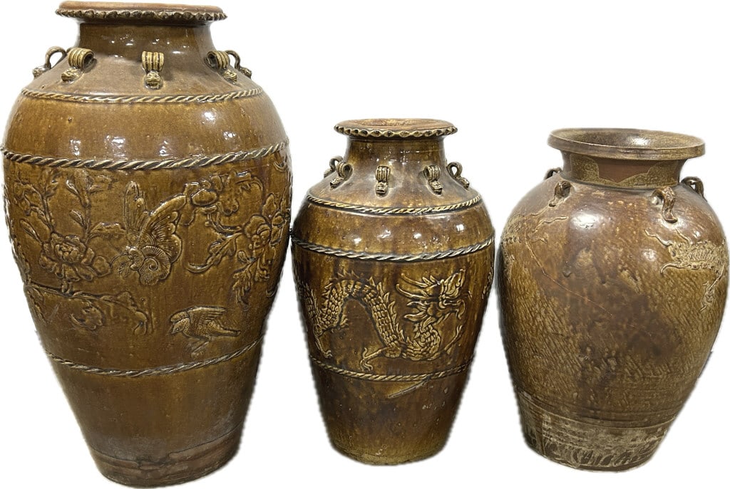 3 Antique Chinese Brown Glazed Martaban Jars.: Largest: 26"Hx14"W. Burmese pottery Late Qing Dynasty, each with rolled rims, shoulder with lugs (for tying down on ship), bulbous bodies, largest has embossed butterfly, bird, floral and foliate