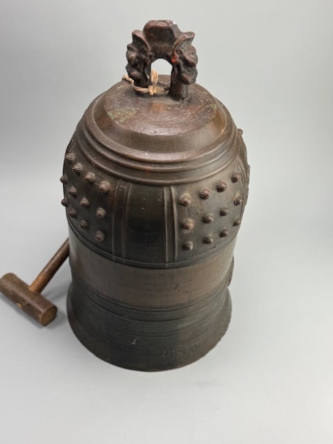 Antique Japanese Bronze Buddhist Temple Bell.: 11"T x 13" W. Likely Meiji period (1868-1912). Known as Bonsho or Tsurigane. Features cast dragon-head supports, known as ryuzu, shoulder having pronounced bosses known as nyu, and embossed and incise